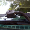 A close-up of two car windshield washer nozzles being sprayed onto a surface.