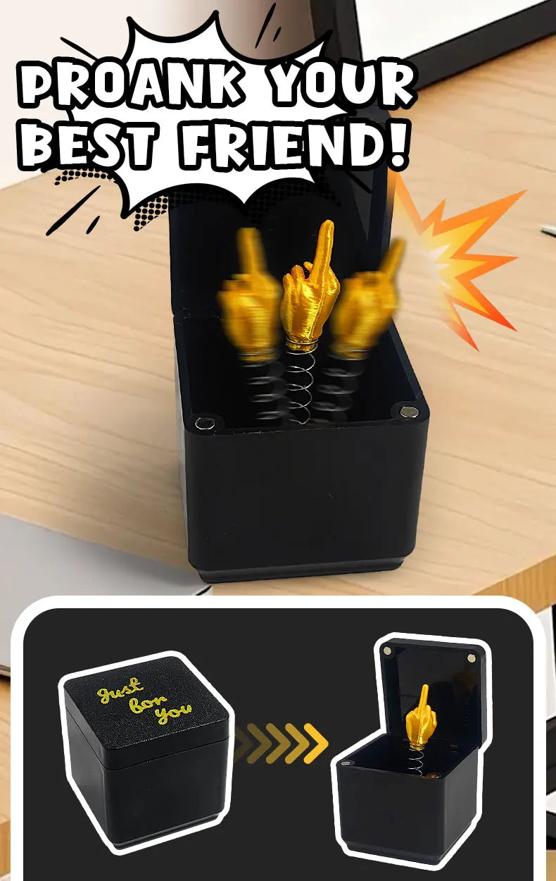 A black box containing three gold middle finger surprise items, shown next to the product packaging.