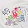 Various colored acrylic alphabet beads arranged on a white plate with measurement lines.