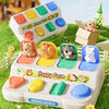 A white Montessori Pop-Up Animal World toy featuring various farm animals in colorful compartments set outdoors.