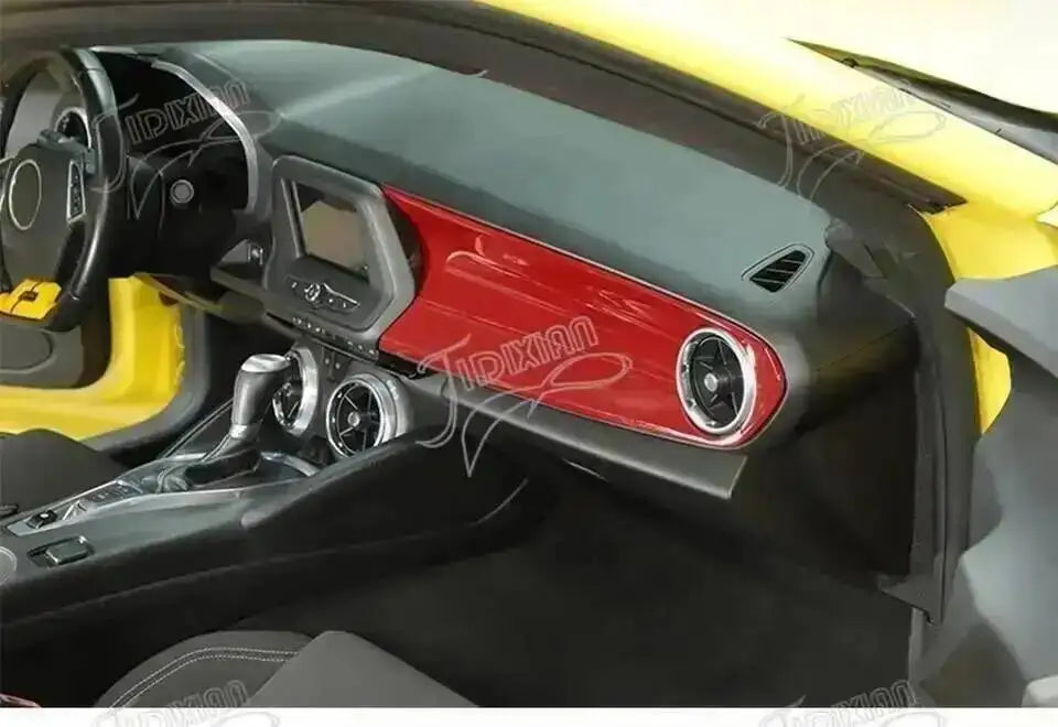 Interior view of a car showing red and black trim components and dashboard details.
