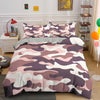 A duvet cover set featuring a pink and purple camouflage pattern on a bed.