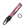 A pink and purple strap keychain featuring Japanese text on a black leather clip.