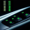 Close-up of a set of glow-in-the-dark car window button stickers with various symbols and lights.