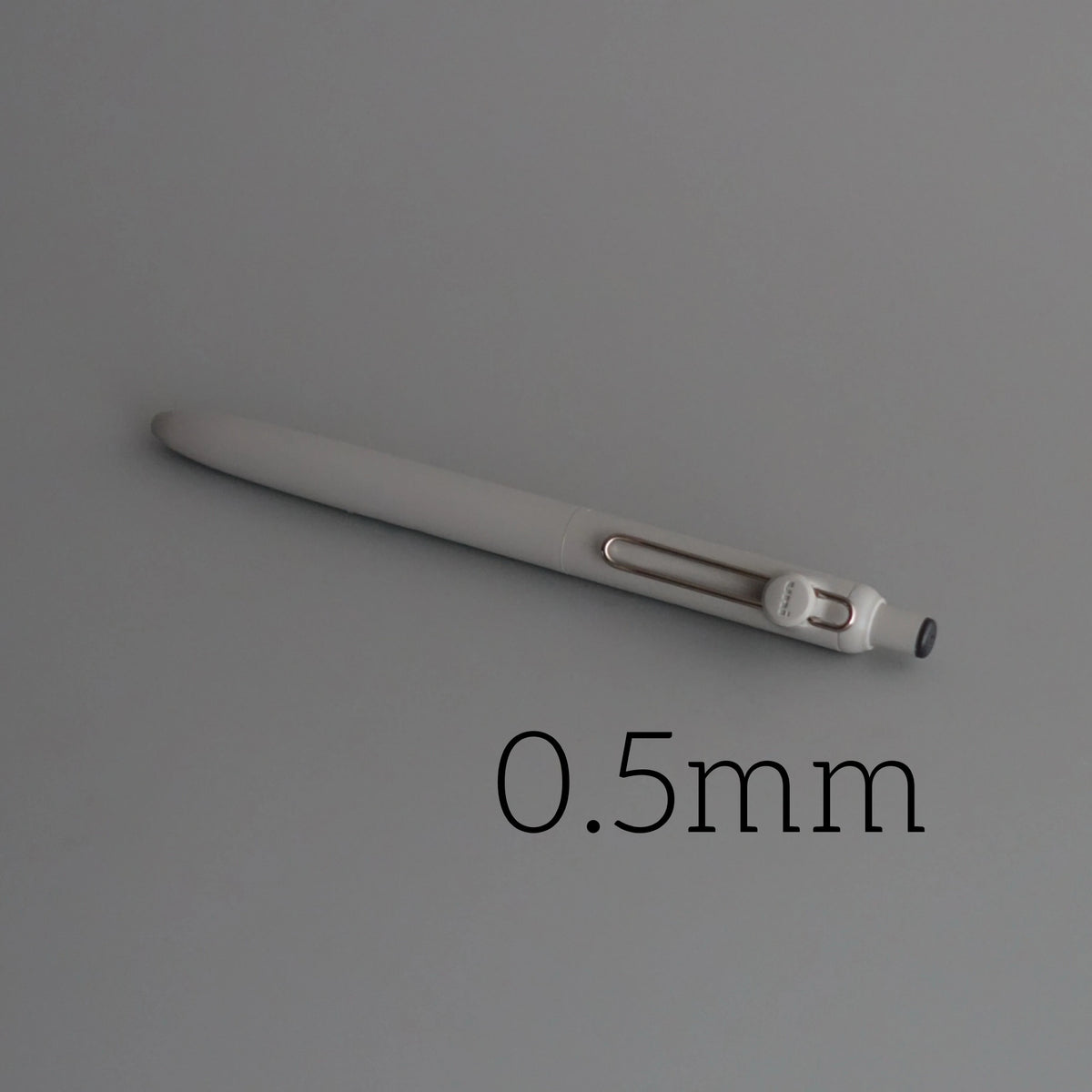 A close-up view of a white Uni ZENTO Quick-Dry Gel Pen with a 0.5mm tip.