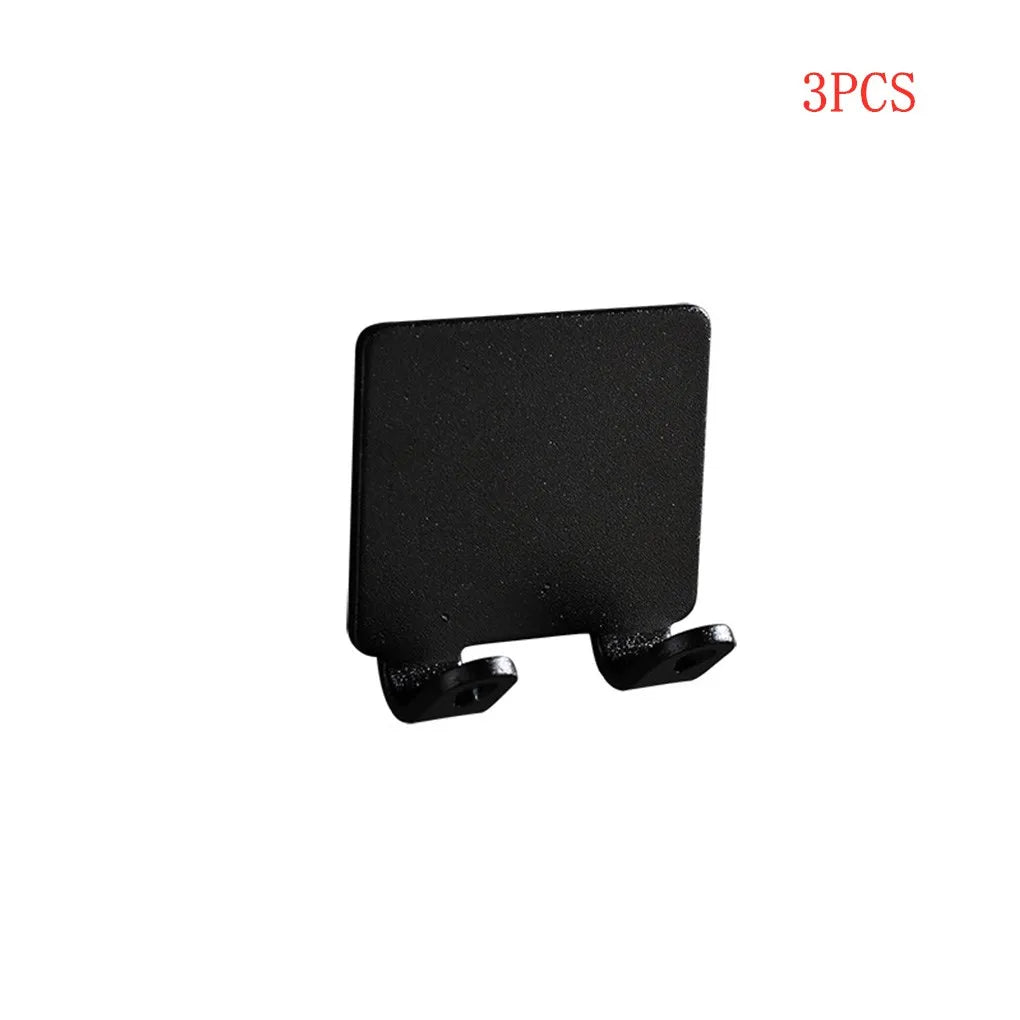 Three black aluminum wall-mounted adhesive razor holders.