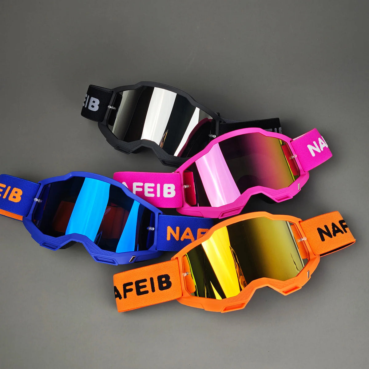 A collection of professional MX off-road goggles in black, pink, blue, and orange, displayed on a gray background.