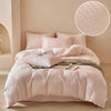 A pink embossed leaf pattern microfiber duvet cover set displayed on a bed with a light neutral background.