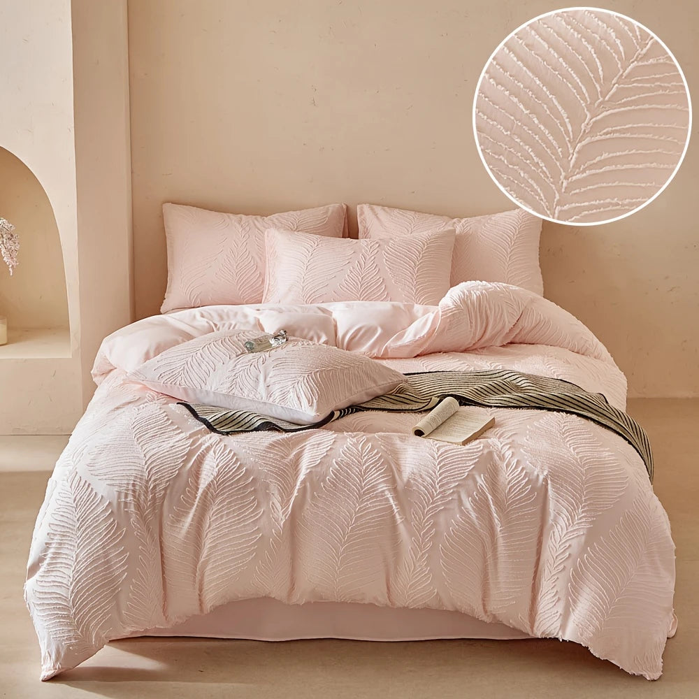 A pink embossed leaf pattern microfiber duvet cover set displayed on a bed with a light neutral background.