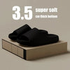 Black cloud thick-soled EVA slides displayed on a wooden surface.