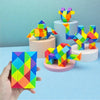 A hand holds a colorful, geometric puzzle toy with vibrant rainbow colors.