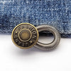 A round brass button with the word FASHION engraved on it and a silver spring-loaded extender.