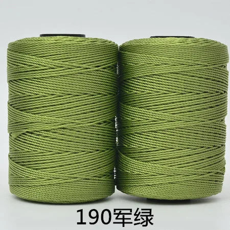 Two spools of 190-count green polyester knitting yarn for crochet and hand crafts