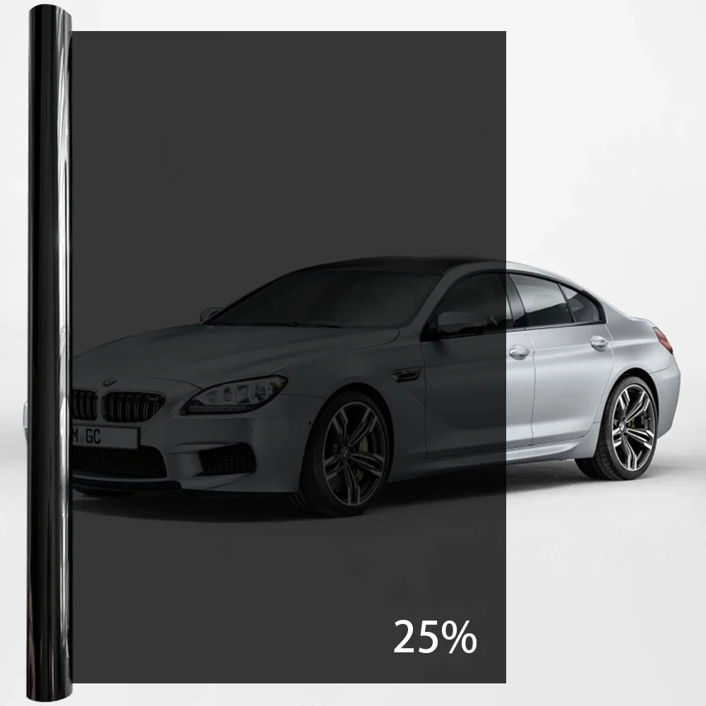 A silver BMW sedan with a black privacy tint film applied to the windows.