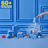 A collection of Mini Brands toys and miniature furniture items displayed on a blue surface.