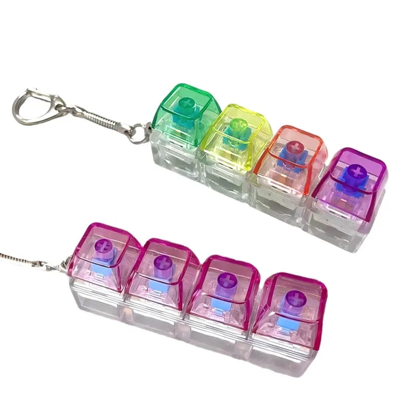 A set of colorful LED light-up keyboard keychain fidget toys in various translucent colors.