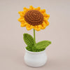 Handcrafted crochet sunflower with a brown center and yellow petals growing in a white pot