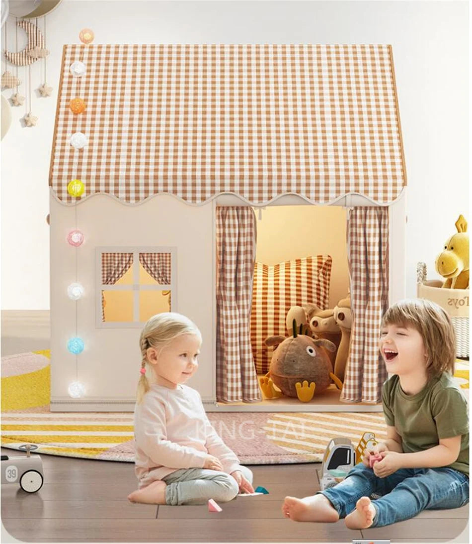 Two young children play in a princess castle play tent decorated with a checkered roof and fabric curtains.