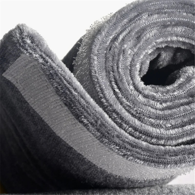 A close-up of a soft velvet anti-skid protector for refrigerator handles, rolled up and textured.