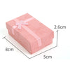 Pink velvet jewelry gift box with a pink ribbon and cushioned insert