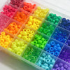 A clear plastic box filled with various colored pony and letter beads for crafting projects