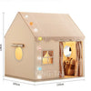 A beige princess castle play tent with a checkered roof and a window featuring a mirror.