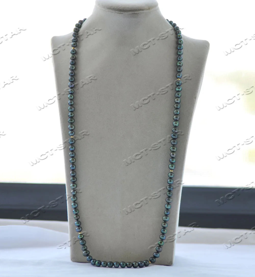 A necklace featuring small blue and green freshwater pearls displayed on a neutral-colored mannequin neck.