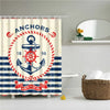 A fabric shower curtain featuring a nautical theme with anchors and stripes.