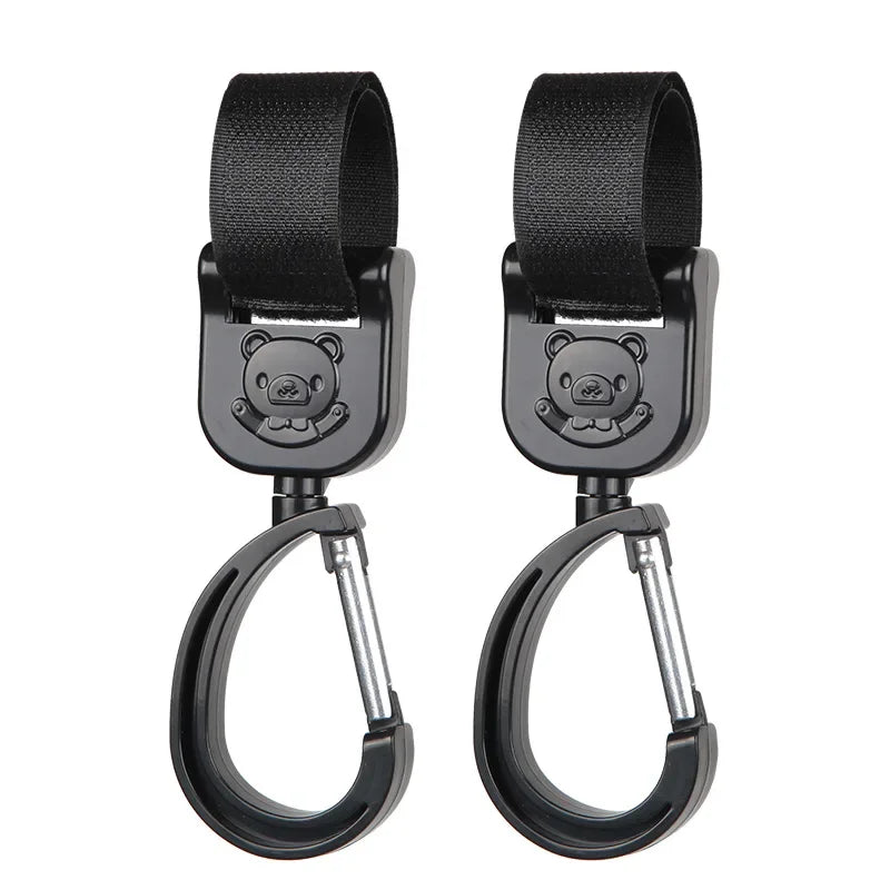A pair of black 360° rotating stroller hooks designed for hanging bags and essentials.