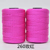 Two spools of bright pink 3-ply polyester knitting yarn for crochet and hand crafts