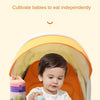 A baby is eating from a plate in a stroller snack tray with a cup holder and phone slot.