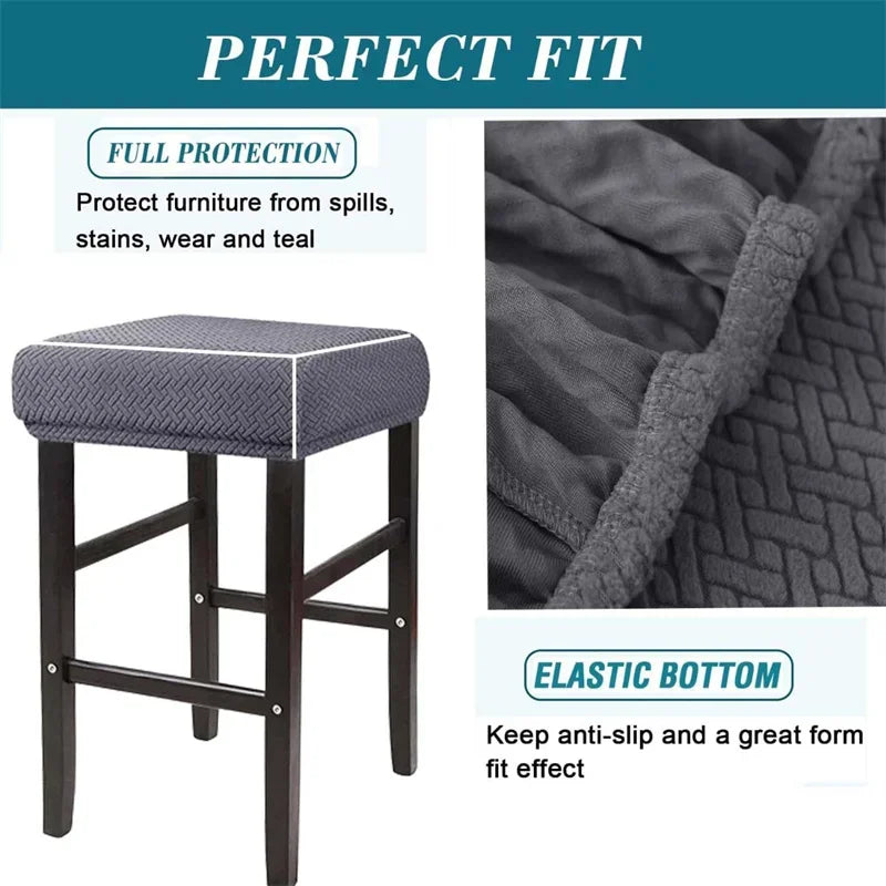 A dark gray fabric bar stool slipcover featuring a textured pattern and an elastic bottom for a perfect fit.