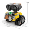 Set de bloques de construcción mini robot amarillo y gris con ojos negros grandes y una planta verde en la parte superior.