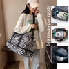 A woman holds an animal print sports and fitness bag with wet/dry compartments.