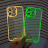 A hand holds a glow-in-the-dark neon clear phone case for an iPhone, showing bright green and yellow light.