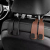Black car headrest hooks with leather straps for securing bags and organizers