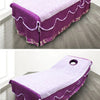 Purple disposable bed sheet with white scalloped trim displayed on a floor.