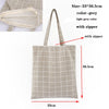 A light grey checkered canvas tote bag with a zipper, shown flat and standing.
