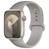 A silver silicone sport band for an Apple Watch shown on a white background.