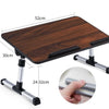 Adjustable foldable laptop desk with a dark wood surface and metal legs shown in a top-down view.
