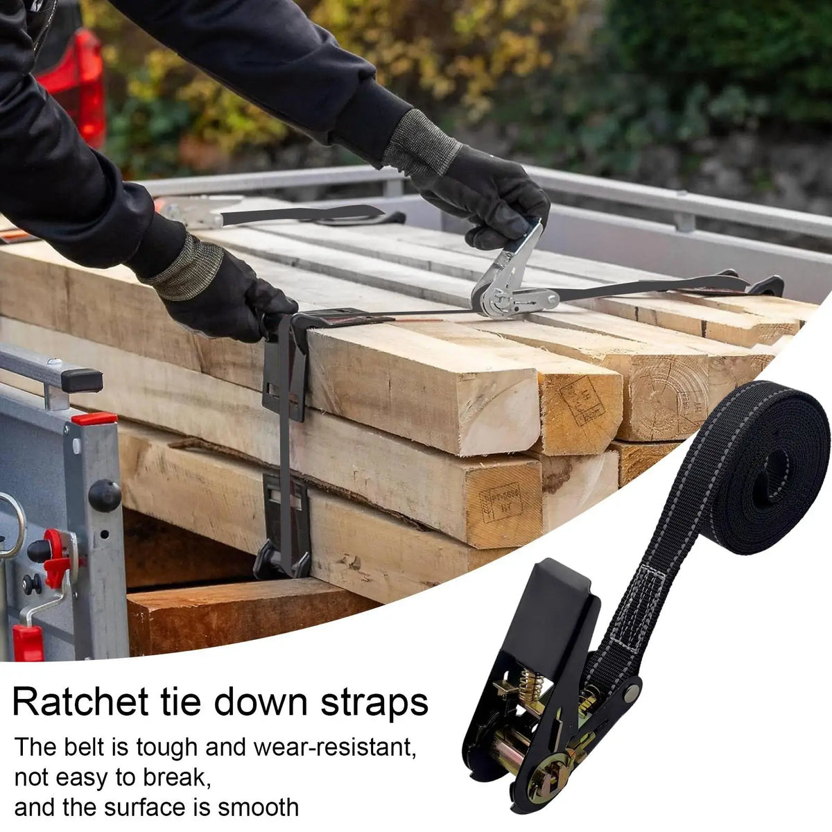 Close-up of heavy duty ratchet tie down straps being used to secure wooden planks on a flatbed.