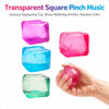 A hand holds four transparent square pinch music stress relieving toys in various colors: pink, blue, and green.