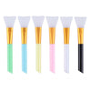 A set of six silicone facial mask brushes with gold and colored handles.