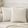 A white knitted textured throw pillow cover with a subtle vertical ribbed pattern on a light gray sofa.