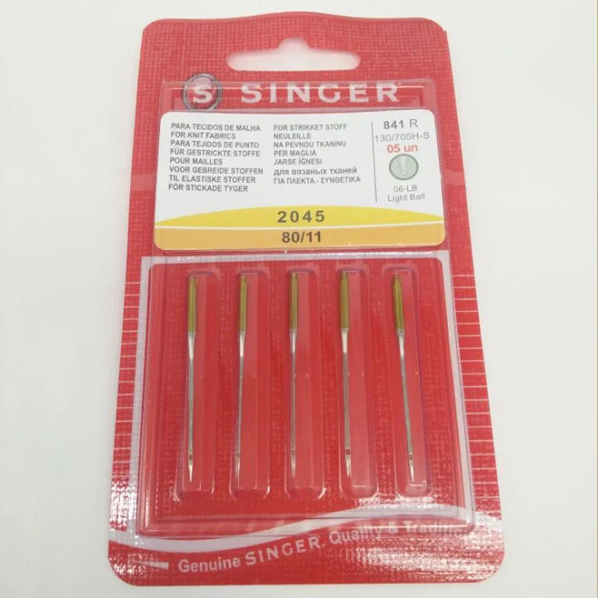 A package of five Singer sewing machine needles in a clear plastic case with a red background.