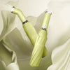 A close-up of a lime green automatic three-fold umbrella with silver accents, shown against a light background.