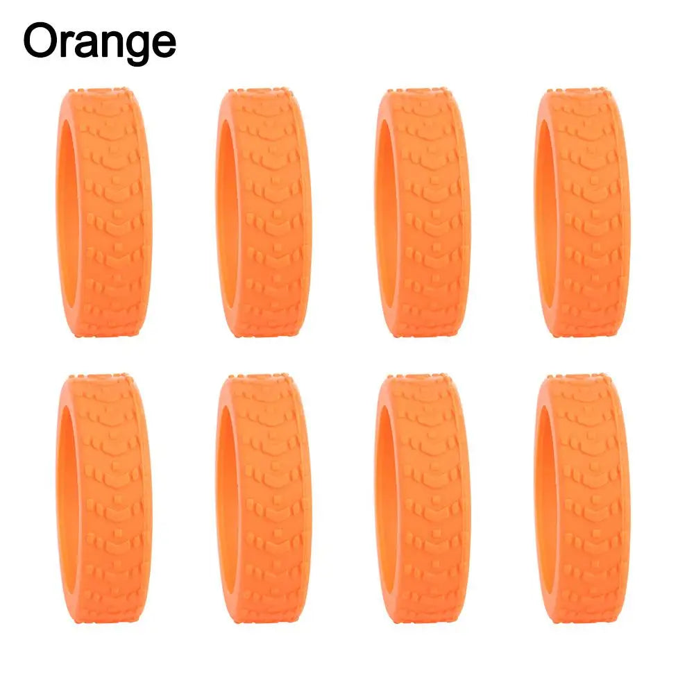 A set of orange silicone luggage wheel protectors designed to prevent scratching and reduce noise during travel.