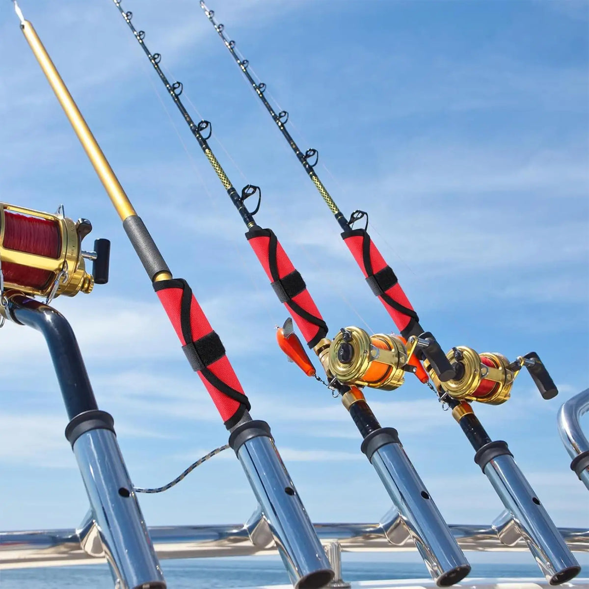 A close-up view of four fishing lure hook covers with rods and hooks against a blue sky.