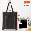 Black canvas tote bag with an A4 sized rectangular insert and a handle shown against a white background.