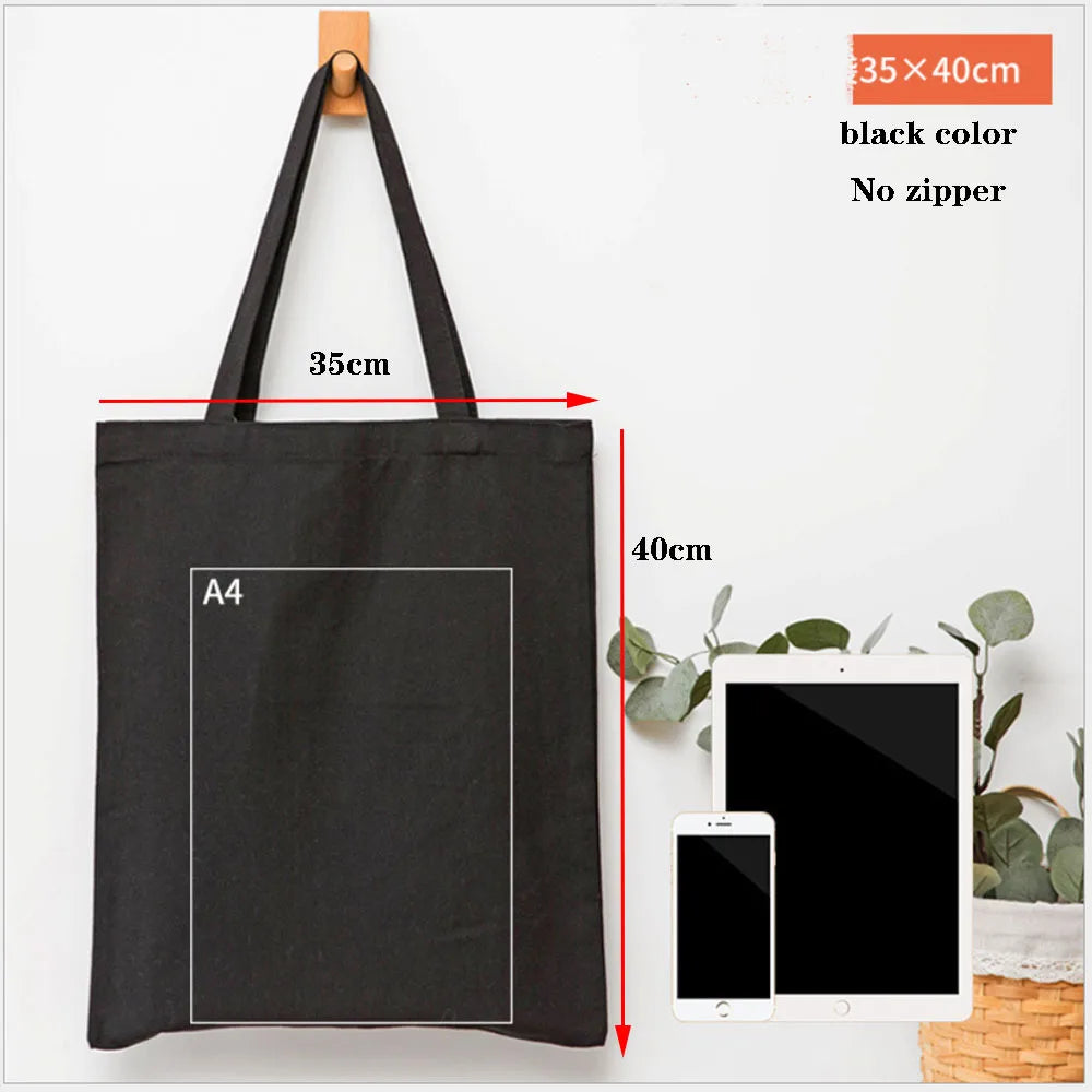 Black canvas tote bag with an A4 sized rectangular insert and a handle shown against a white background.